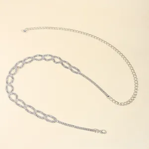 Detail of silver chain belt with layered oval rings and sparkling crystal rhinestones