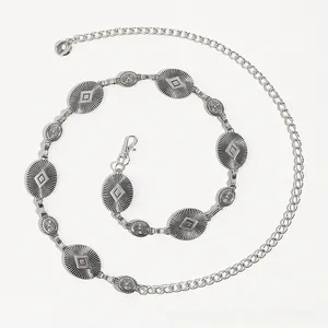 Close-up of bohemian silver waist chain with vintage metal oval plaques and adjustable link