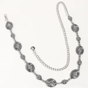 Detail of bohemian silver waist chain with engraved metal discs and adjustable clasp