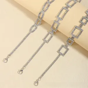 Detail showing silver rhinestone waist chains with square links and lobster clasps