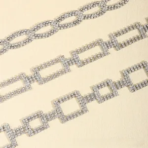 Detailed macro view of three silver rhinestone waist chains with geometric link patterns