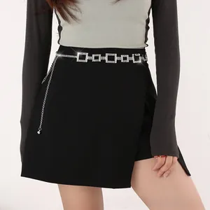 Detail of silver rhinestone waist chain with square modules on a black dress