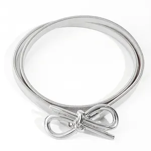 Detail of silver elastic metal spring belt with a polished bow-shaped buckle