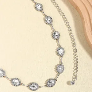 Close-up of elegant silver waist chain with oval crystal pendants and sparkling rhinestones