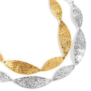 Detailed macro view of hammered metal leaf texture on gold and silver waist chains