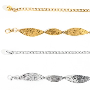Detailed view of metal leaf waist chains in gold and silver with lobster clasps