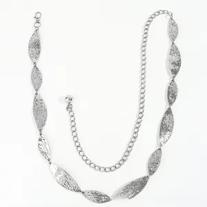 Detailed view of silver metal leaf chain belt with hammered texture and adjustable clasp