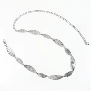 Detail of silver leaf metal chain belt with hammered texture and adjustable clasp
