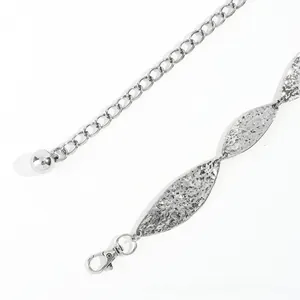 Macro shot of silver metal leaf waist chain with hammered texture and lobster clasp