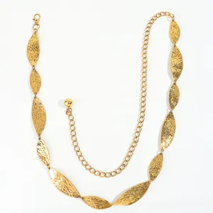 Detailed macro view of golden leaf-shaped metal links with hammered texture on the waist chain