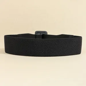 Detail of a black elastic wide waist belt with square metal buckle and leather patches
