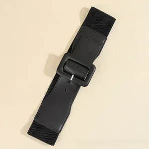 Detailed view of black wide elastic belt with large rectangular buckle for dresses