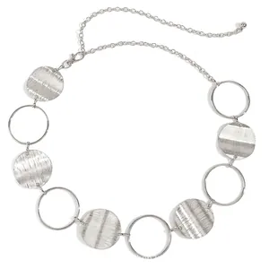 Close-up of vintage silver metal waist chain with textured discs and lobster clasp closure
