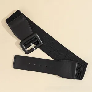 Detail of a wide black elastic waist belt for women with a matte faux leather pin buckle