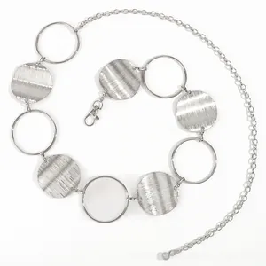 Detail of silver metal waist chain with textured round discs and lobster clasp
