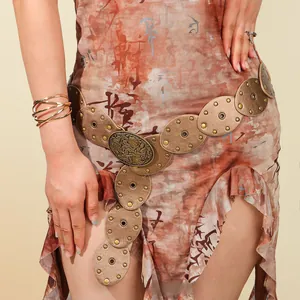 Détail de la ceinture vintage Y2K en similicuir avec boucle en métal gaufré et rivets