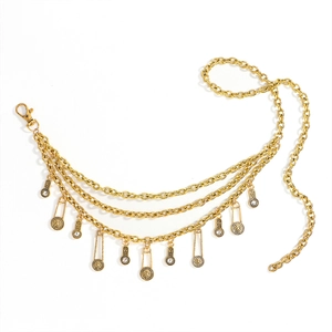 Detail of vintage gold layered waist chain with lion coin charms and crystal accents