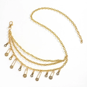 Detail of gold multi-layer waist chain with vintage coin pendants and lobster clasp