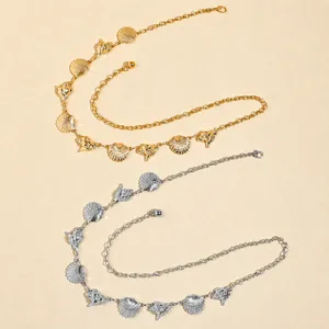 Detail of shell charms in gold and silver finish with fine chain and lobster clasp