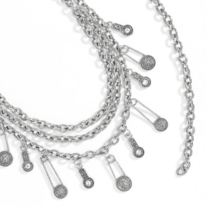 Detail of silver layered chain belt with lion medallion and rhinestone drop charms