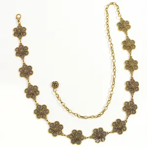 Detailed close-up of golden flower waist chain with lobster clasp and rose pendant