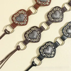 Detail of heart-shaped leather waist belts in brown, dark coffee and black colors
