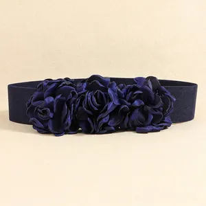 Close-up of navy blue satin flowers and wide elastic fabric on this elegant waist belt