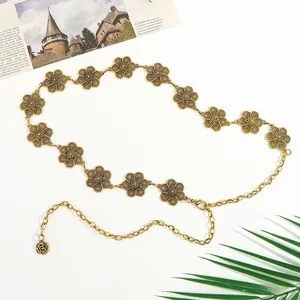 Detailed close-up of retro hollow floral waist chain in vintage gold with lobster clasp