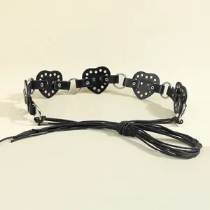 Detail of punk heart-shaped cutout waist belt with silver metal rings and tie closure