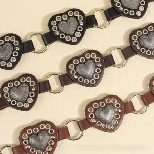 Detail view of heart-shaped PU leather links with metal studs on bohemian belts