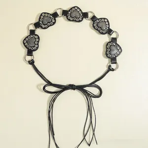Detail of a punk heart waist chain featuring black leather hearts and silver metal eyelets