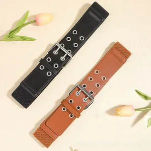 Detail of wide elastic waist belts in black and brown with double row silver eyelets