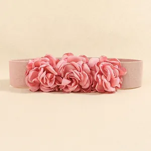 Detailed view of 3D satin rose petals and elastic woven texture on the wide waist belt