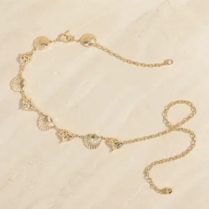 Detailed view of bohemian gold waist chain with shell and seahorse metal pendants