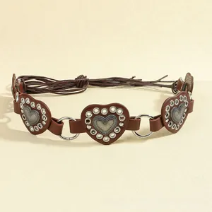 Detail of brown heart-shaped leather waist chain with metallic eyelets and rope ties