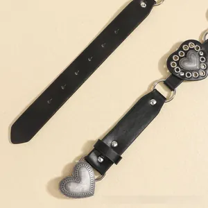 Detailed close-up of a black PU leather belt with silver heart buckles and retro textures