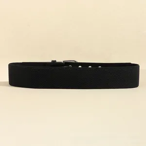 Detail of black elastic wide waist belt with silver metal buckle and leather patches
