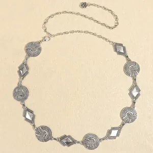 Detail of silver vintage metal waist chain with rose pendant and textured geometric links
