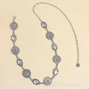 Detail of vintage silver metal waist chain with mandala links and rose charm