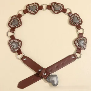 Detail of brown leather belt with vintage heart-shaped metal pieces and circular ring connectors