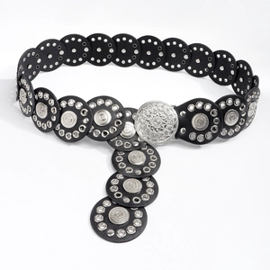 Detail van een bohemian zwarte leren riem met zilveren gesp en metalen oogjes