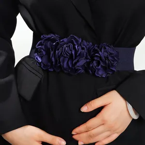 Detail of elegant navy blue satin fabric flower on an elastic waist belt accessory