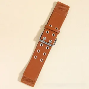Detailed close-up of brown elastic wide corset belt with silver double-pin metal buckles