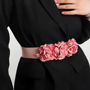 Detailed view of pink satin 3D flower elastic waistband for dress decoration