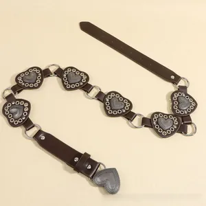 Detail of vintage brown heart belt with silver rings and heart metal studs