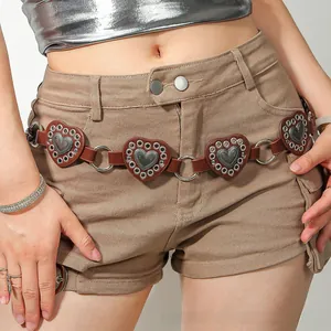 Detail view of heart-shaped brown leather belt pieces linked by silver metal rings