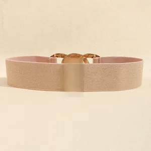 Detail showing elastic champagne waist belt with elegant gold chain link buckle