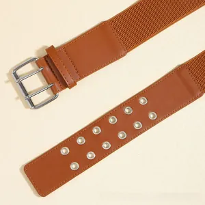 Brown wide elastic belt with double-row silver eyelets and metal pin buckle detail