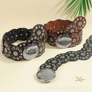 Detail of bohemian leather belts with sunflower metal discs in brown and black