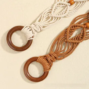 Détail de ceintures tressées bohèmes avec boucles en bois rondes en tons beige et brun